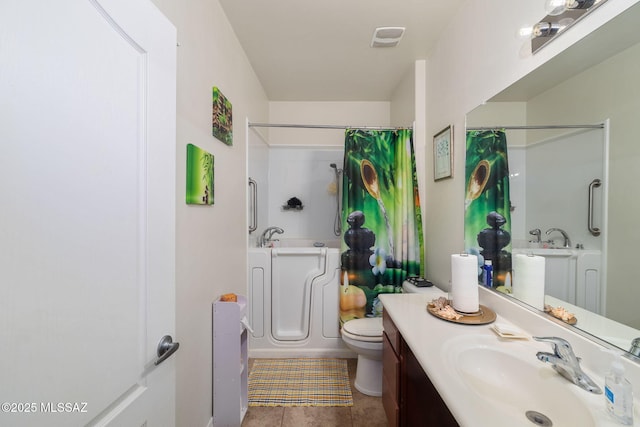 bathroom featuring tile patterned flooring, vanity, and toilet