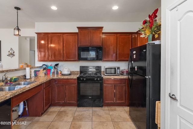 kitchen with light stone countertops, sink, black appliances, pendant lighting, and light tile patterned floors