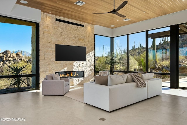 living room with a fireplace, wooden ceiling, and ceiling fan