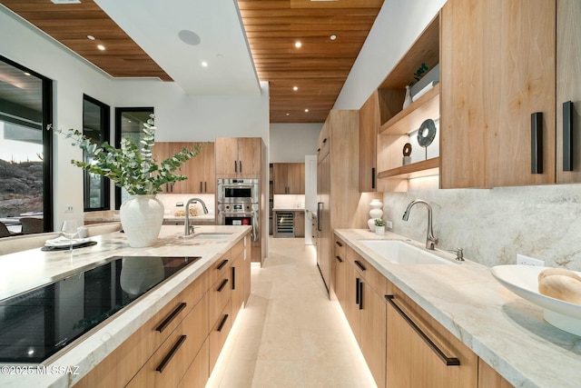 kitchen with black electric stovetop, sink, and wooden ceiling