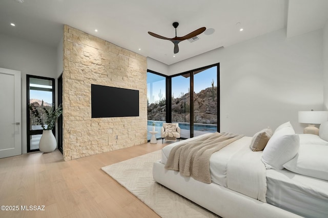 bedroom with ceiling fan, access to outside, and light wood-type flooring