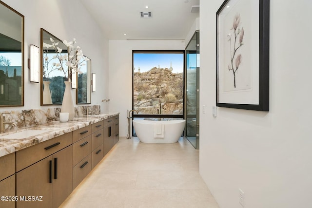 bathroom with vanity and a tub to relax in