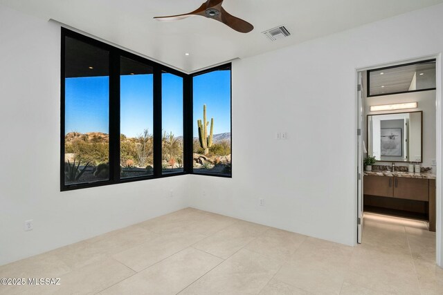 bathroom featuring a skylight, vanity, tile patterned floors, toilet, and walk in shower