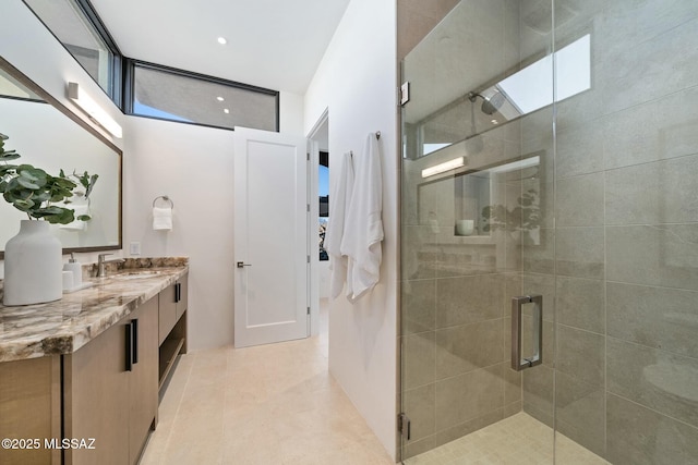 bathroom featuring tile patterned floors, vanity, and an enclosed shower