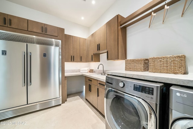 washroom with washer and dryer and sink