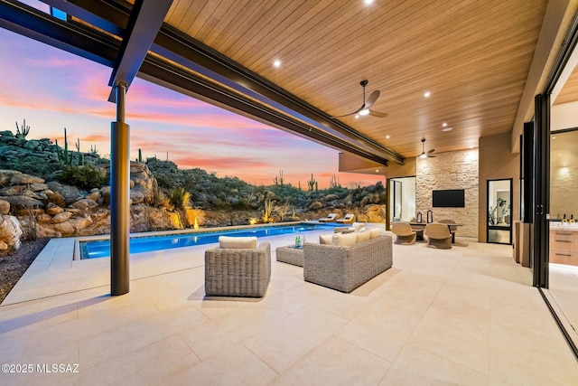 view of patio / terrace with ceiling fan and an outdoor living space