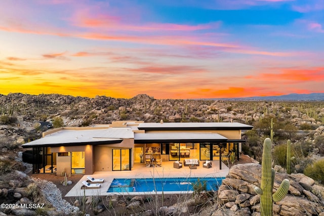 exterior space with a mountain view and a patio area