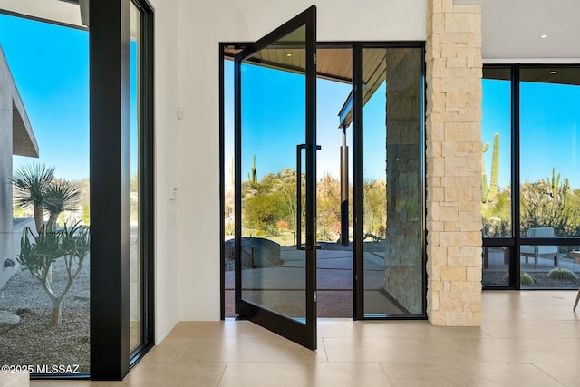 doorway to outside featuring expansive windows