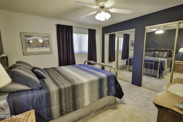 carpeted bedroom with a textured ceiling and ceiling fan