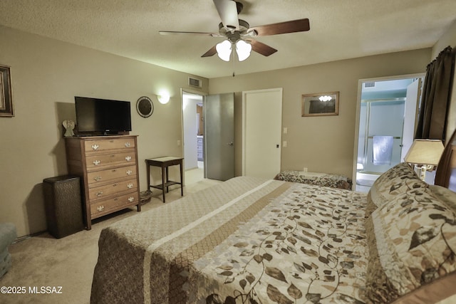 carpeted bedroom with a textured ceiling, ceiling fan, and ensuite bathroom