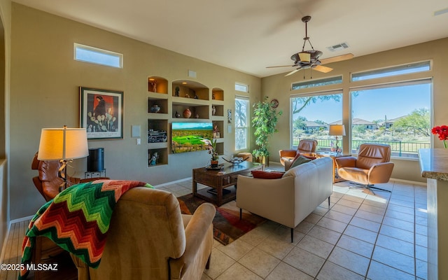 living area with a wealth of natural light, visible vents, built in features, and light tile patterned flooring