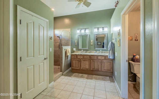 bathroom featuring double vanity, toilet, tile patterned flooring, a walk in shower, and a sink