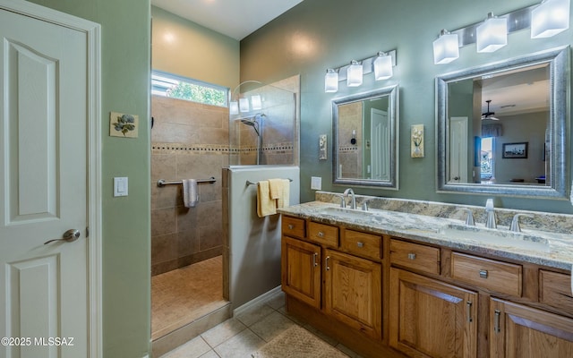 bathroom featuring tile patterned flooring, double vanity, a sink, and a walk in shower