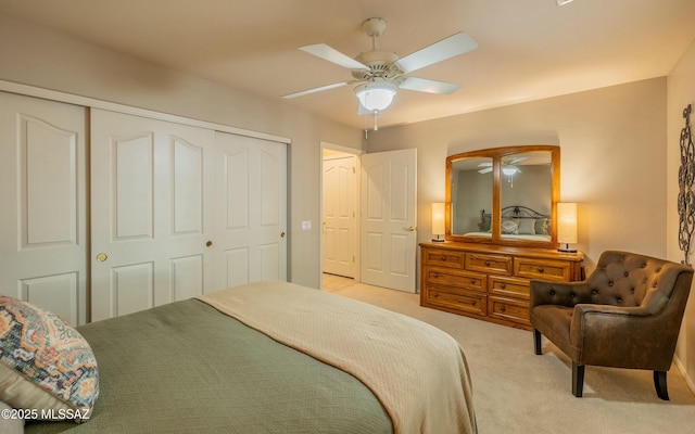 bedroom with a closet, light carpet, and ceiling fan