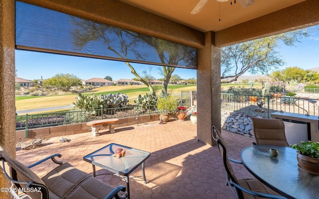 view of patio featuring ceiling fan, fence, and outdoor dining area