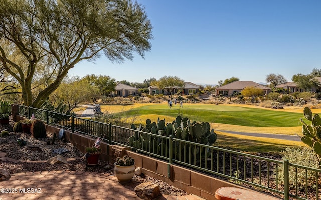 view of yard featuring fence and golf course view