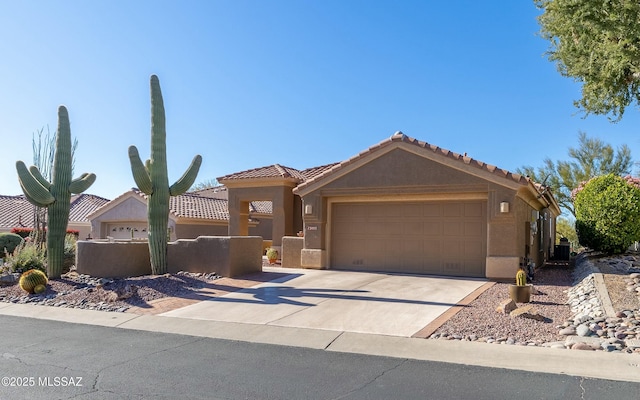 view of front of property with a fenced front yard, an attached garage, a tile roof, concrete driveway, and stucco siding