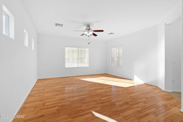 unfurnished room with light wood-type flooring and ceiling fan