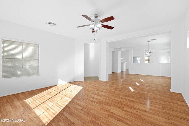 unfurnished living room featuring ceiling fan and light hardwood / wood-style floors