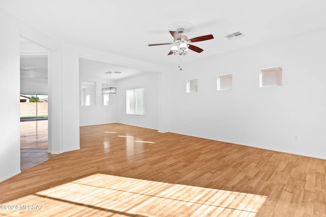 interior space with ceiling fan, light wood-type flooring, plenty of natural light, and basketball hoop