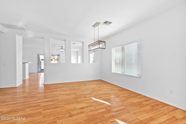 empty room with ceiling fan and light wood-type flooring