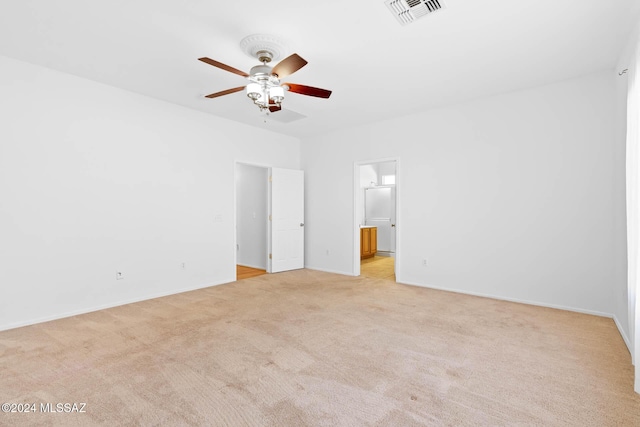 unfurnished bedroom featuring ensuite bath, ceiling fan, and light colored carpet