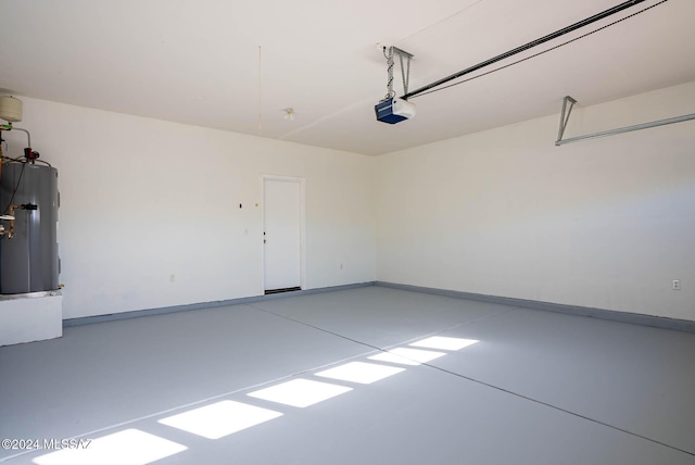 garage with electric water heater and a garage door opener