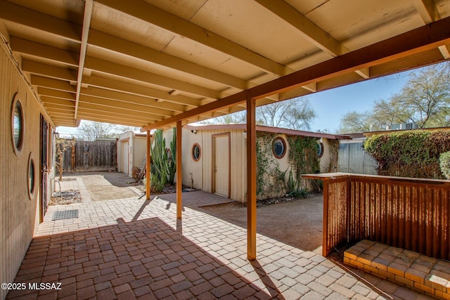 view of patio featuring a storage unit