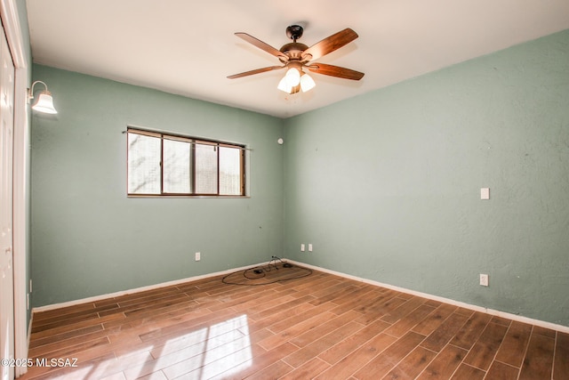 spare room featuring wood-type flooring and ceiling fan