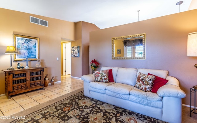 living room featuring vaulted ceiling and light tile patterned floors