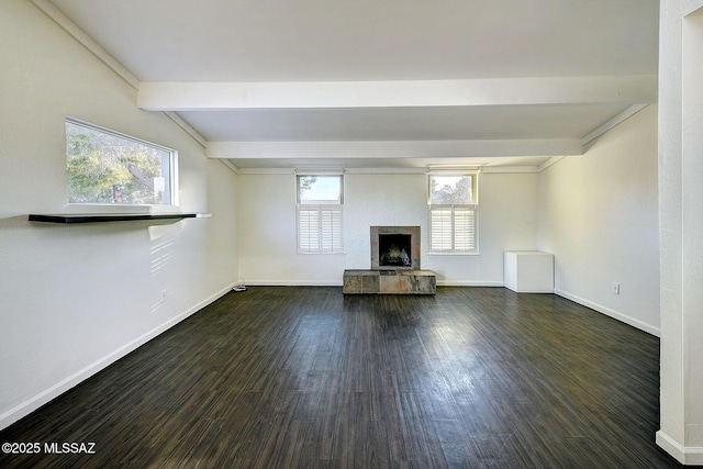 unfurnished living room with dark hardwood / wood-style flooring and lofted ceiling with beams