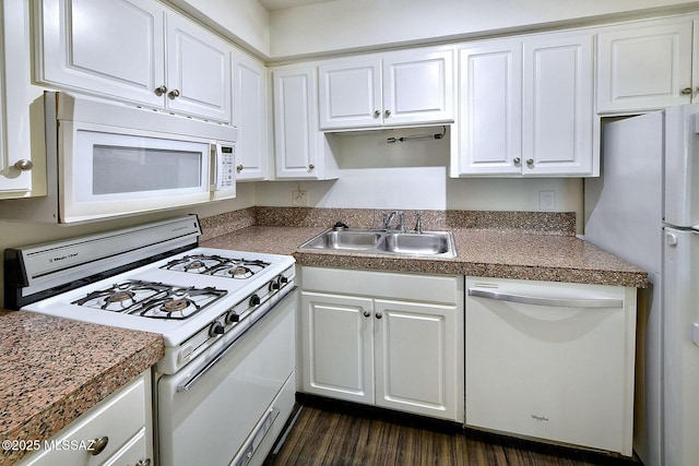 kitchen featuring dark hardwood / wood-style flooring, sink, white cabinets, and white appliances