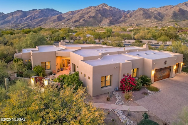 view of front of property featuring a mountain view and a garage