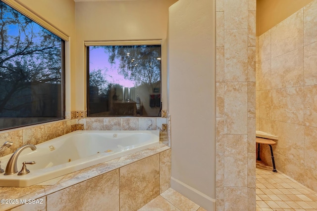 bathroom featuring tiled tub and tile patterned floors