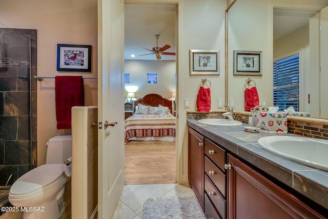 bathroom with ceiling fan, vanity, tile patterned floors, and toilet