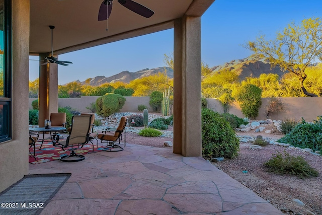 view of patio / terrace featuring ceiling fan and a mountain view