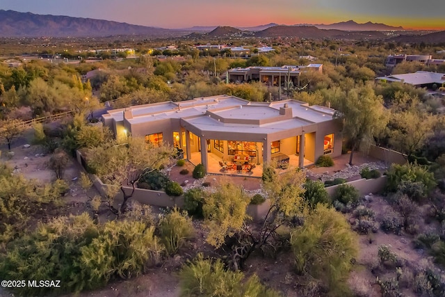 aerial view at dusk featuring a mountain view