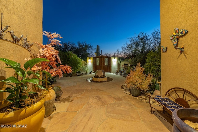 view of patio terrace at dusk