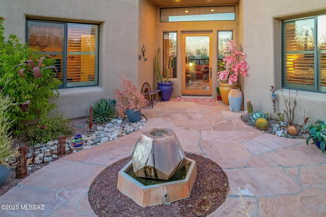 entrance to property with a patio