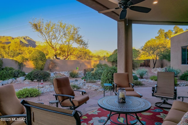 view of patio / terrace with ceiling fan and a mountain view