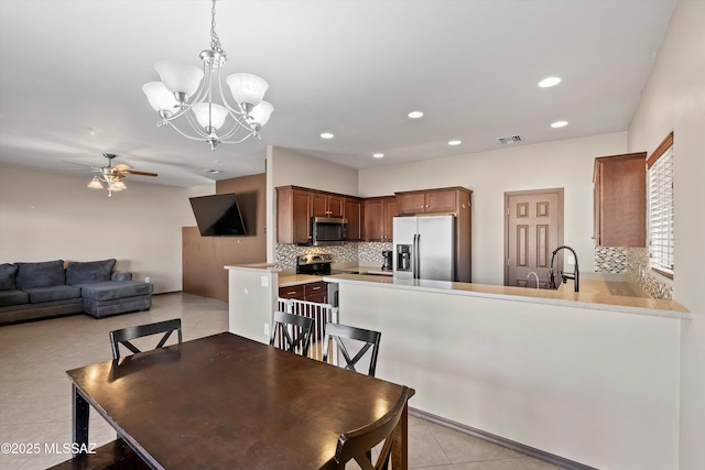 7585 E Majestic Palm Ln, Tucson, AZ 85756 - dining space featuring a ceiling fan, light tile patterned flooring, recessed lighting, and a chandelier