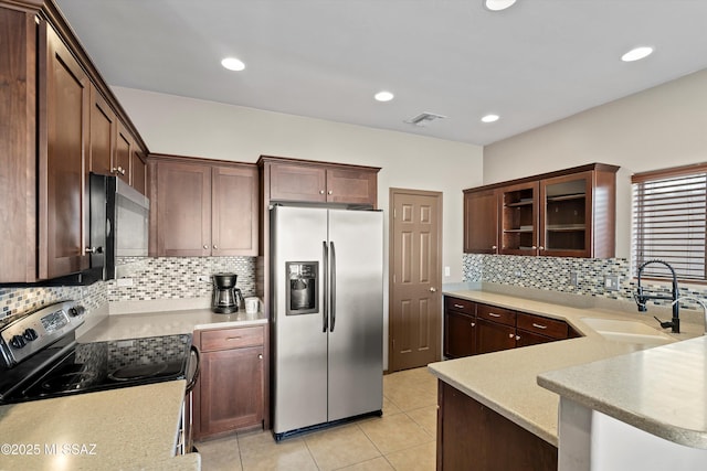 7585 E Majestic Palm Ln, Tucson, AZ 85756 - kitchen featuring appliances with stainless steel finishes, a sink, tasteful backsplash, light countertops, and light tile patterned floors