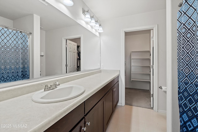 7585 E Majestic Palm Ln, Tucson, AZ 85756 - full bathroom featuring vanity, curtained shower, and baseboards