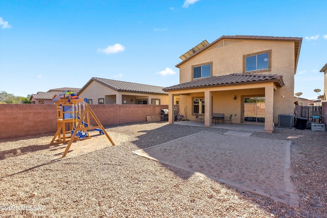 7585 E Majestic Palm Ln, Tucson, AZ 85756 - back of house with stucco siding, a tiled roof, a fenced backyard, a playground, and a patio