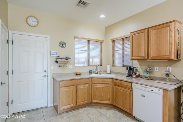 kitchen with white dishwasher, light tile patterned flooring, and sink