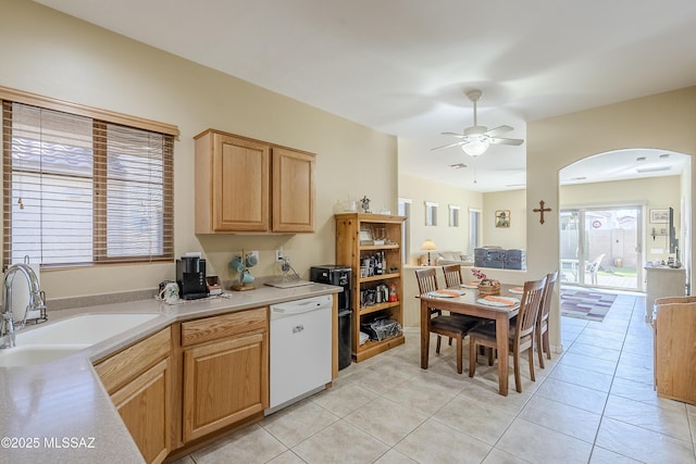 kitchen featuring light brown cabinetry, ceiling fan, sink, light tile patterned floors, and dishwasher