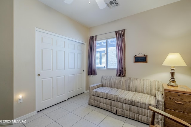 sitting room featuring ceiling fan and light tile patterned flooring