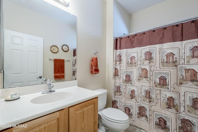 bathroom with curtained shower, vanity, and toilet