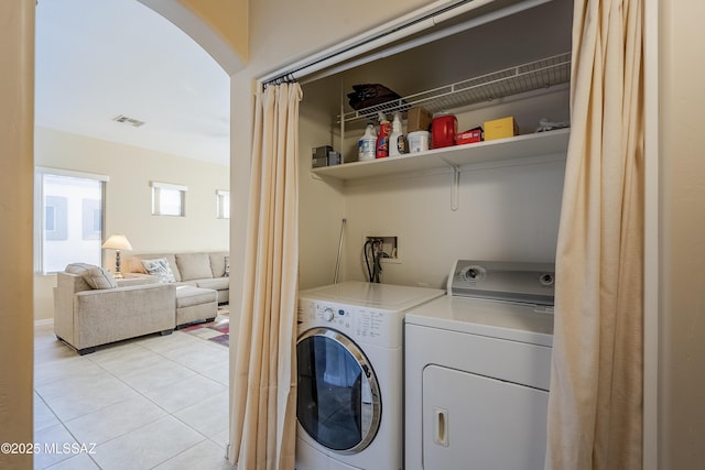 washroom with separate washer and dryer and light tile patterned floors