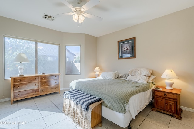 bedroom featuring multiple windows, ceiling fan, and light tile patterned floors